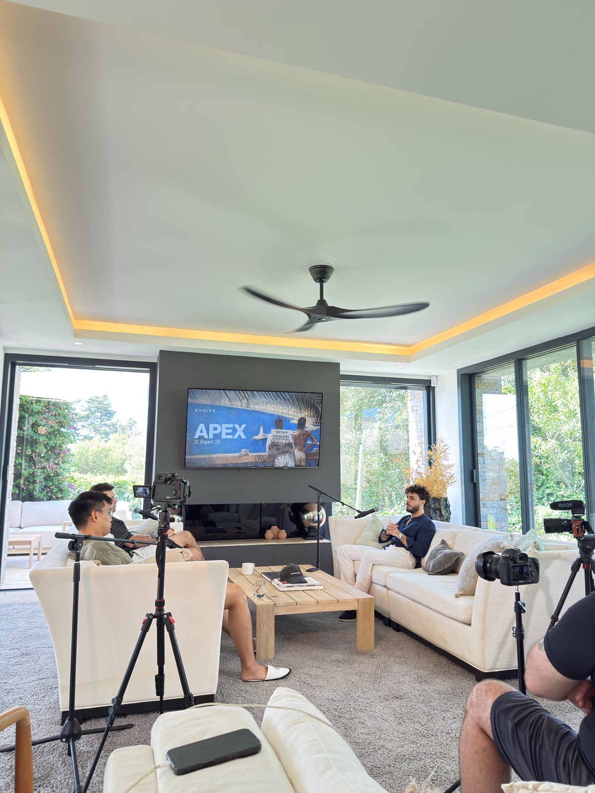 A filmed podcast set with cameras, microphones and two hosts across from Nicolò